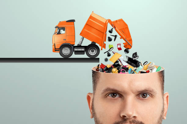 Garbage in the head, clogging up the head with unnecessary information. Garbage truck unloads garbage into the head